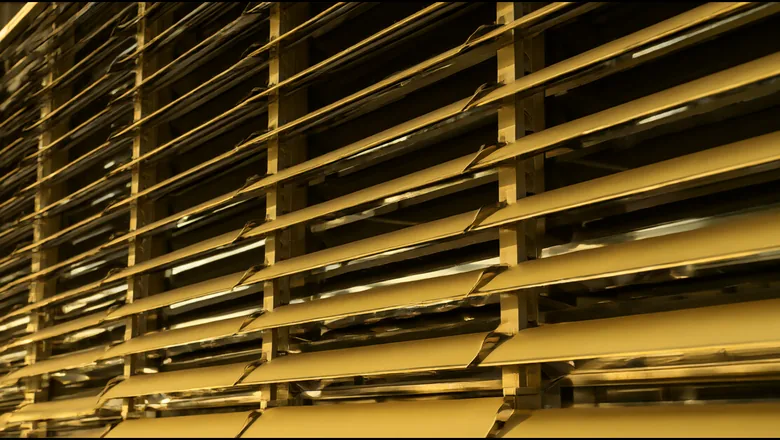 Kinetic facade glare control: 150 mm blades at 190 mm pitch with a 15 degree resting angle