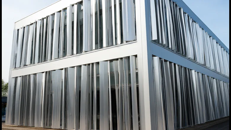 Kinetic facade test bay: aluminium louver blades set at different rotation angles on a two-storey mock-up