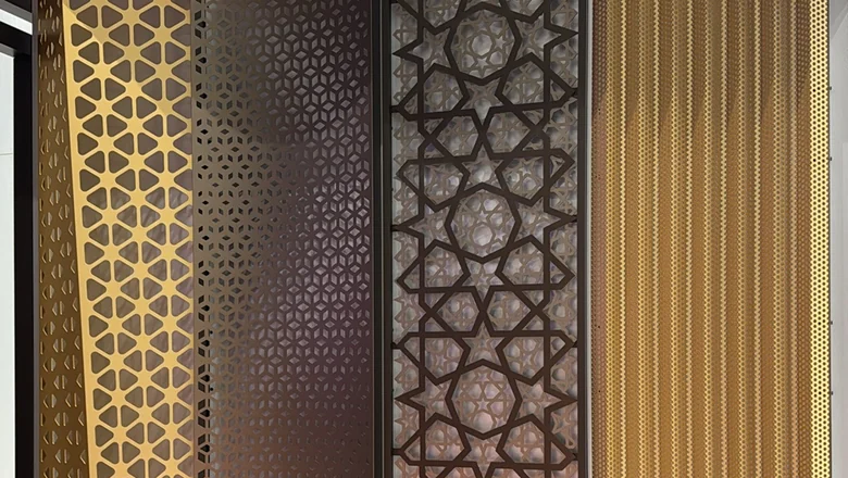 Laser-cut aluminum screens in gold and dark bronze with geometric mashrabiya patterns