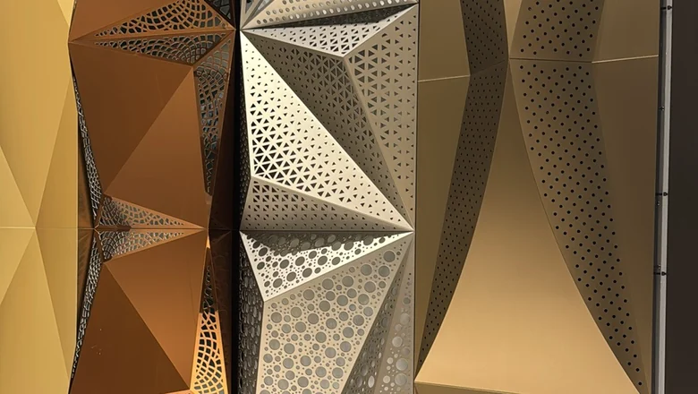 Anodized 3D aluminum feature panels with laser-cut perforation in gold and silver