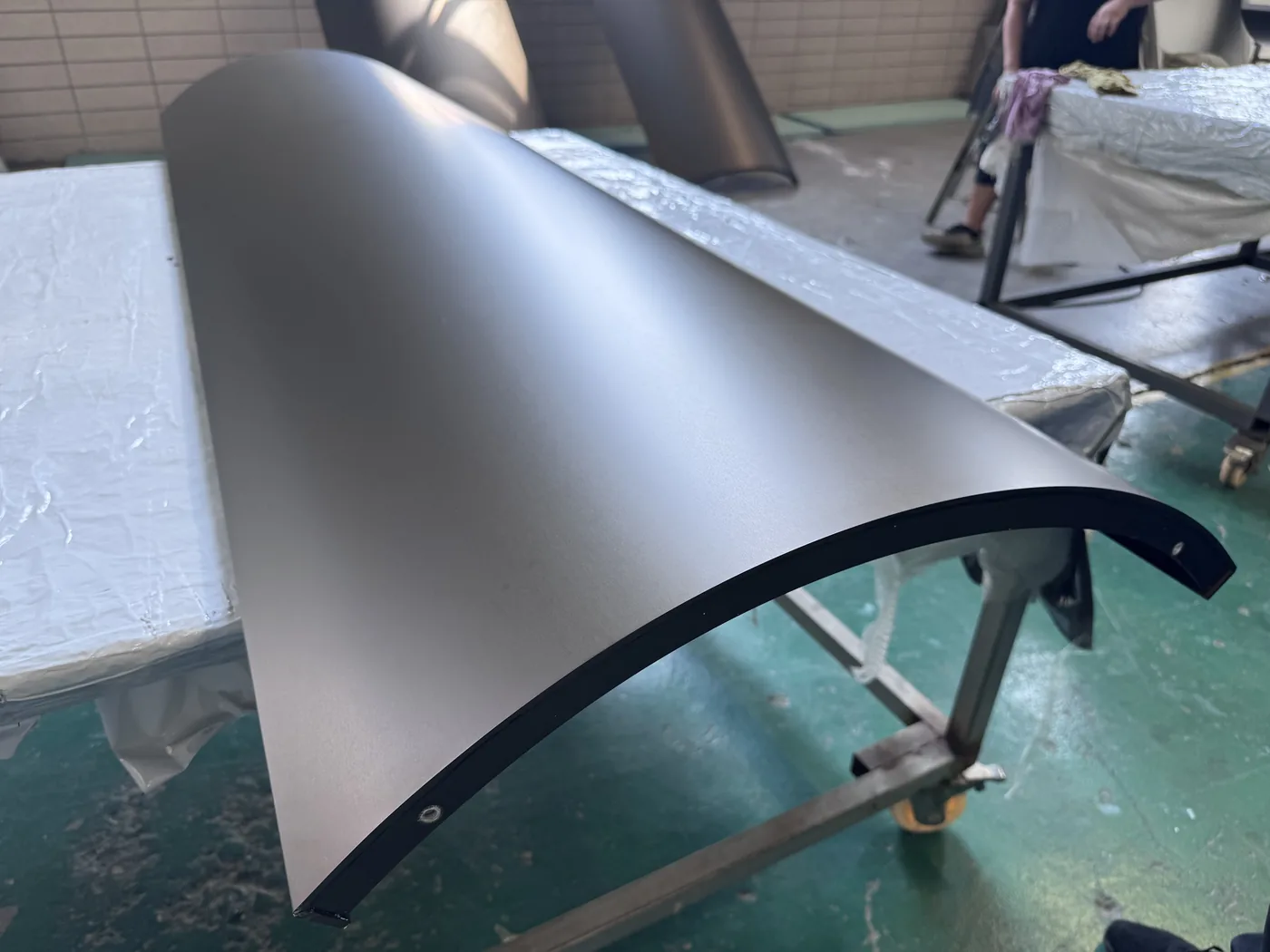 Curved aluminum facade panel during installation